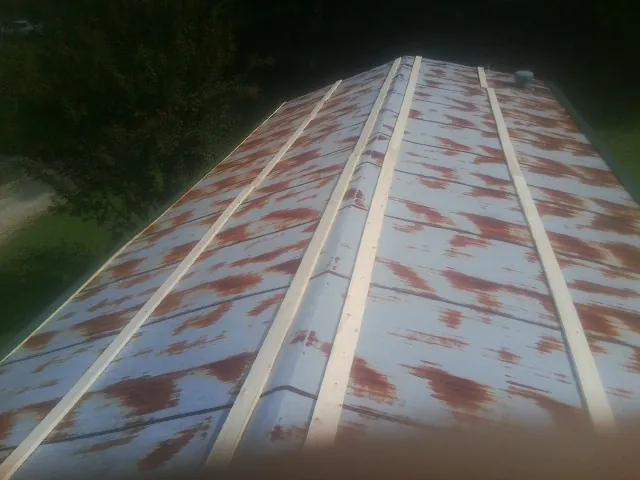 Rusted metal roof panels with new wood purlins before replacement — Storm Damage Roof Repair in Gerlaw by Roofing Brothers